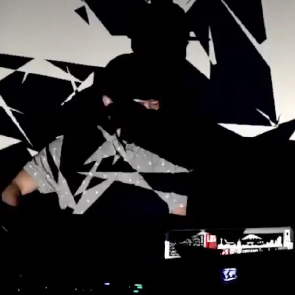 Abstract headshot showing Rook with projections on his head and a table with electronic beat-making tools.  